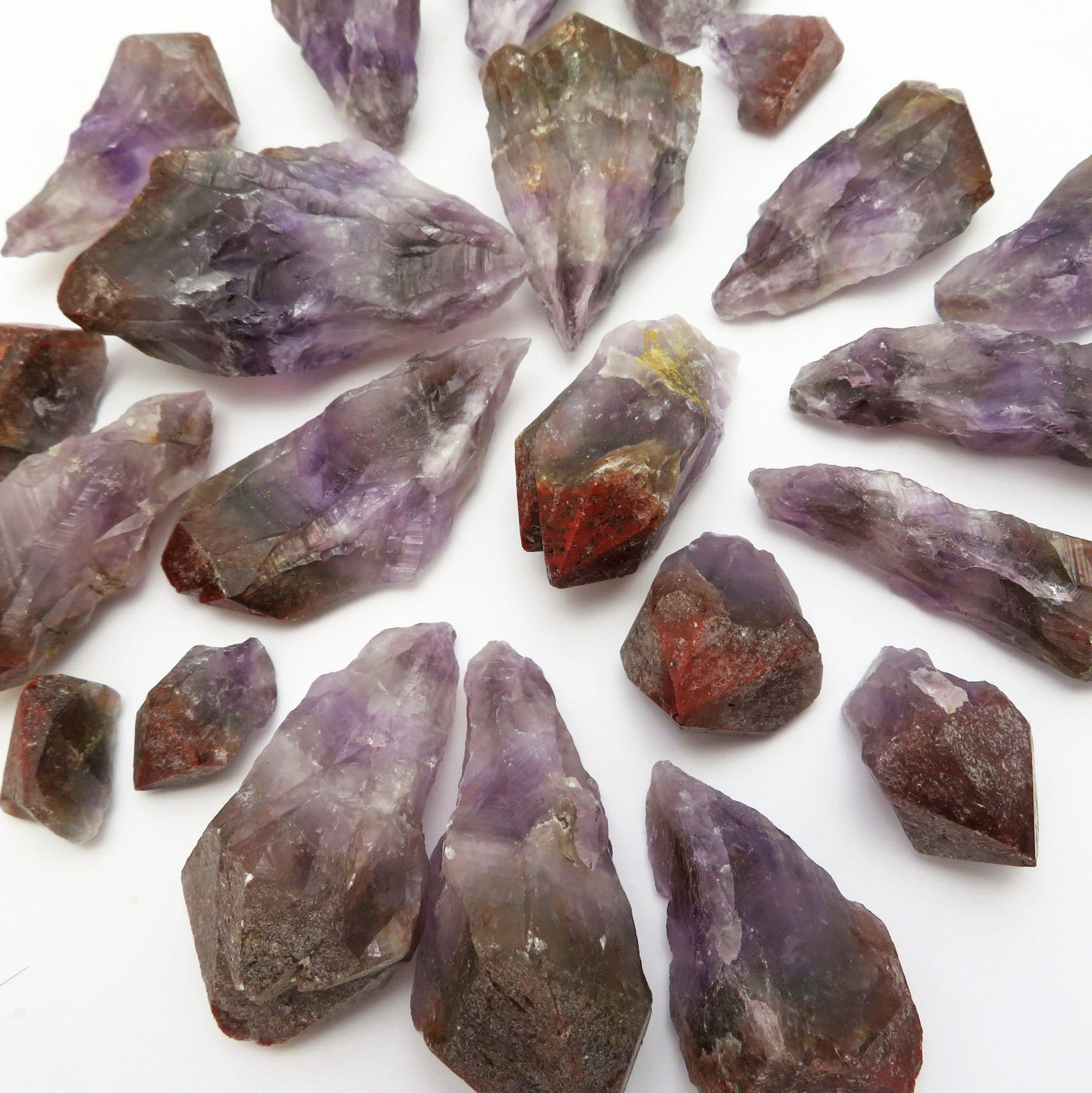 many seven minerals in one stone rough points on white backdrop