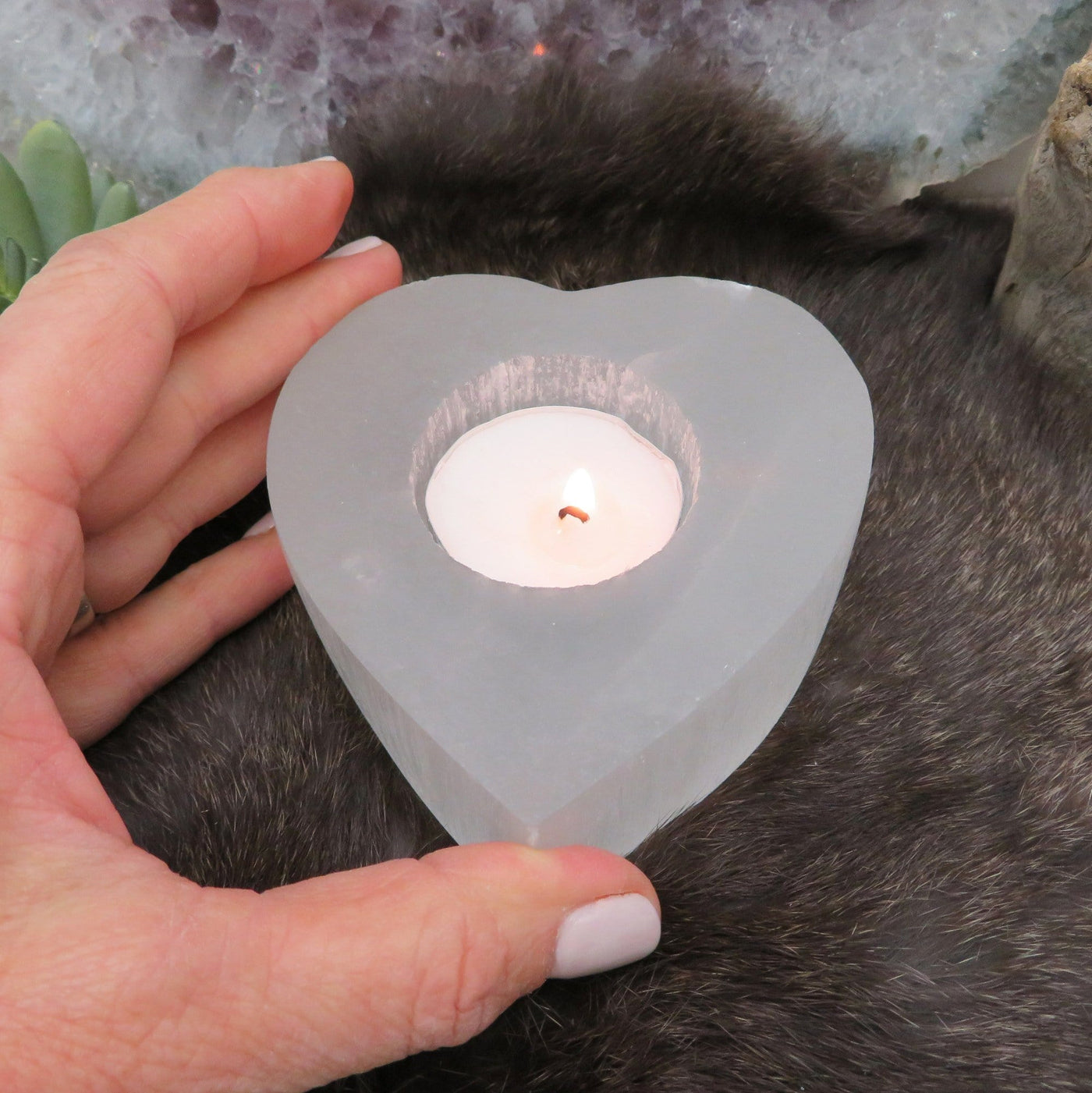 selenite heart shaped candle holder in hand for size reference