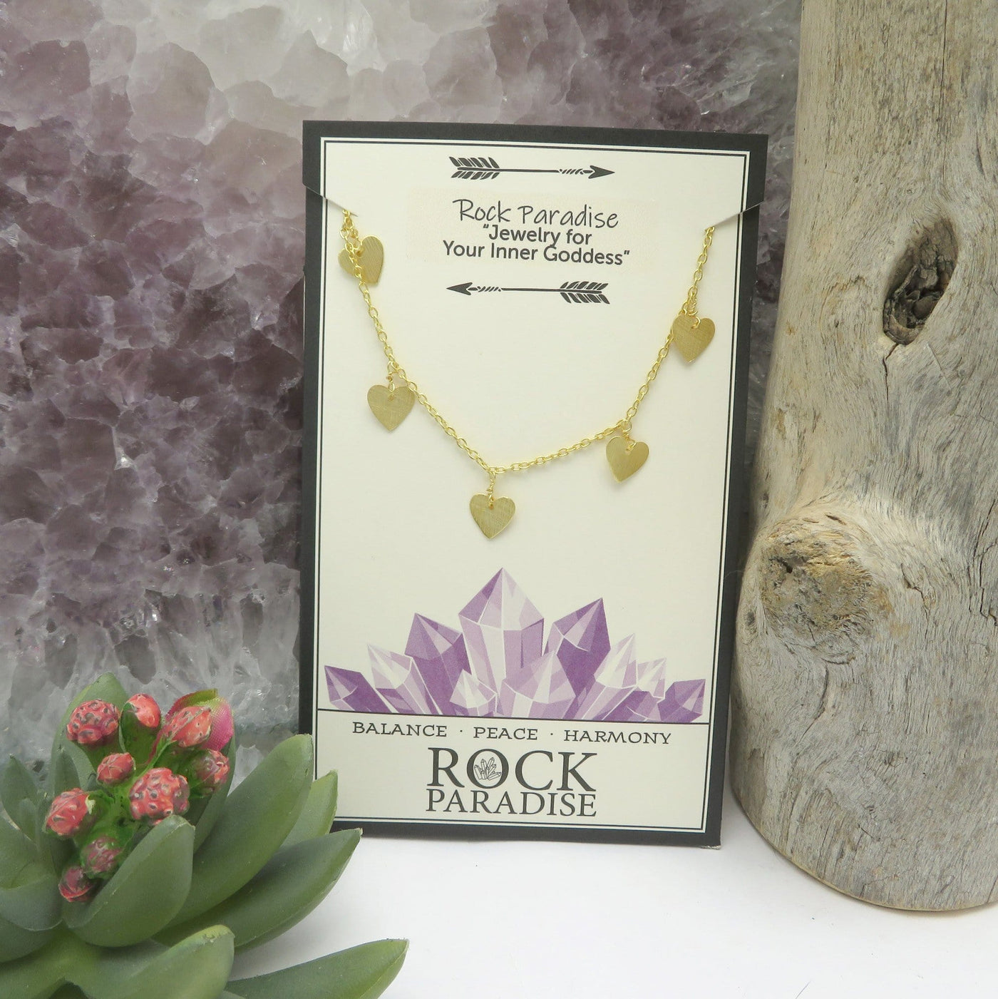 Single Gold Heart Dangle Chain Necklace displayed on rock paradise card