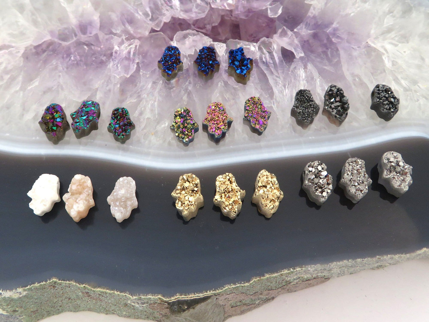 head drilled hamsa bead titanium druzy in assorted colors shown against light and dark backgrounds