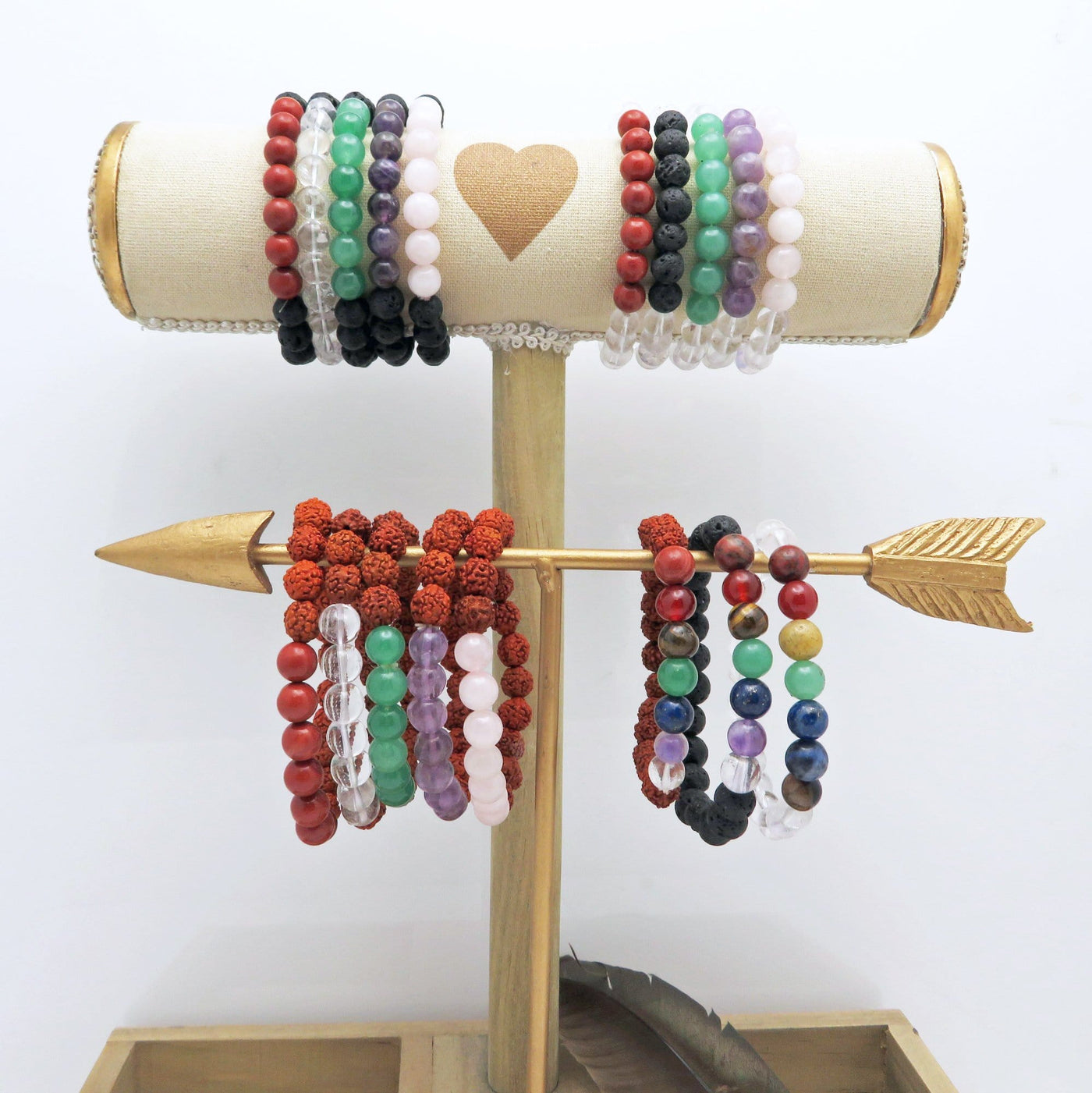 different healing stone bracelets on a display stand with white background