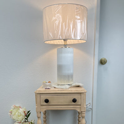 selenite lamp with silver base turned on in natural light