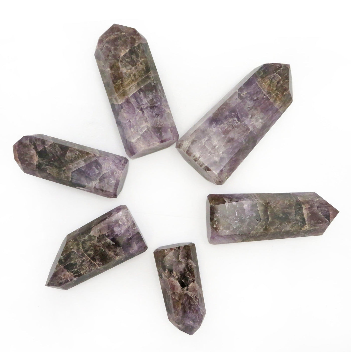 many seven minerals in one cut base points laying flat in a star formation