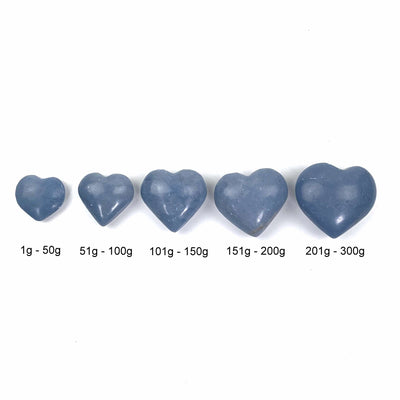 the 5 angelite hearts lined up to show their size differences.