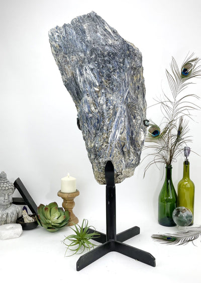 Blue Kyanite Extra Large on metal stand  with decorations in the background