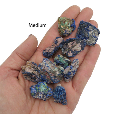 raw azurite stone pieces in hand for size reference 