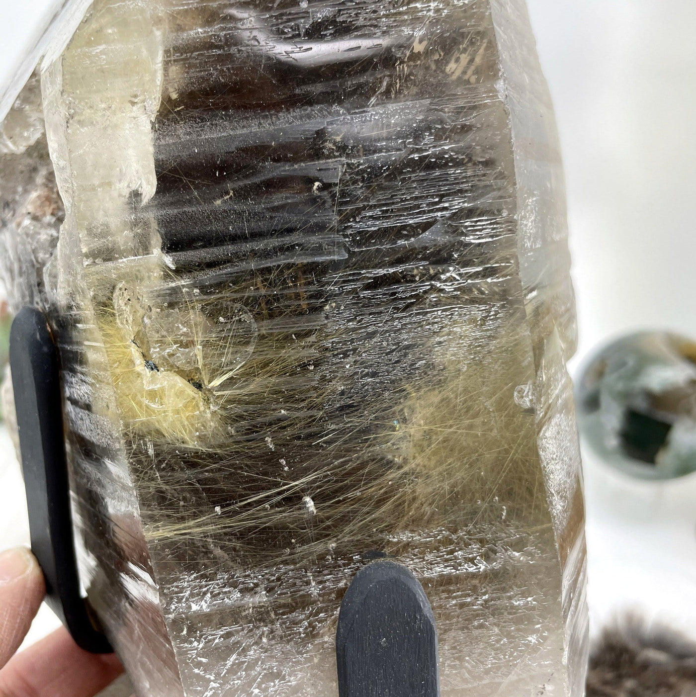 close up of smokey quartz cluster pm revolving metal base for details