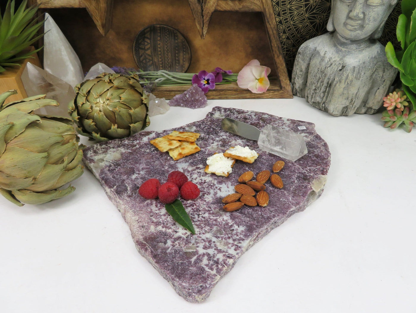 Lepidolite Platter with food on it and decorations in the background