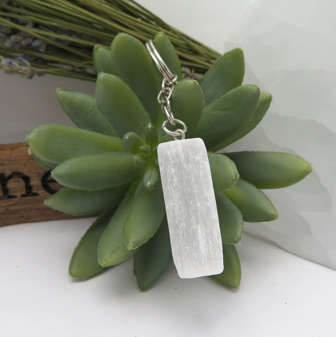 one selenite silver toned key chain in on display for details