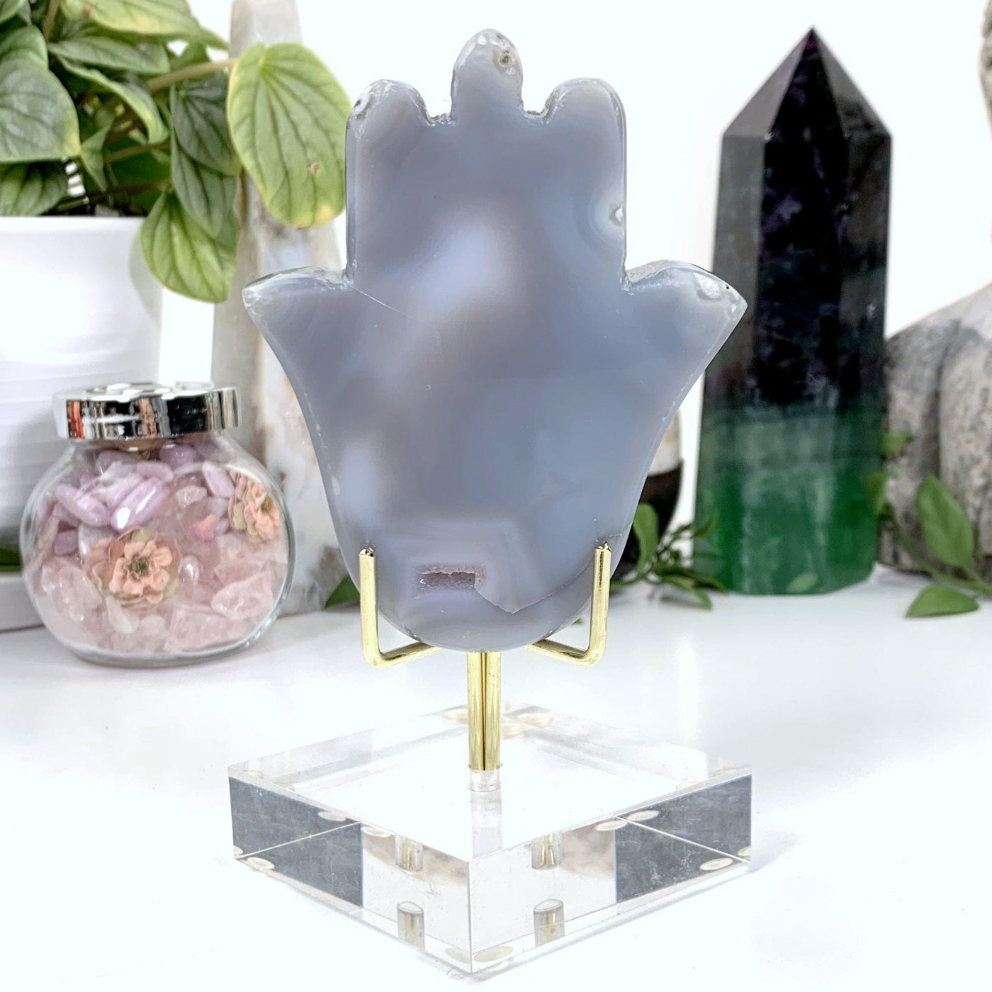 Natural Agate Hamsa Hand with Druzy Center - back of hand on an acrylic stand