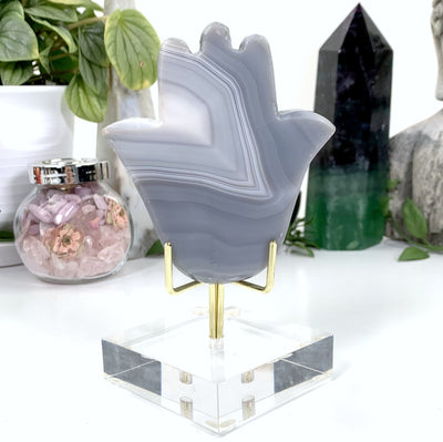 other side of hamsa hand on display stand with white background