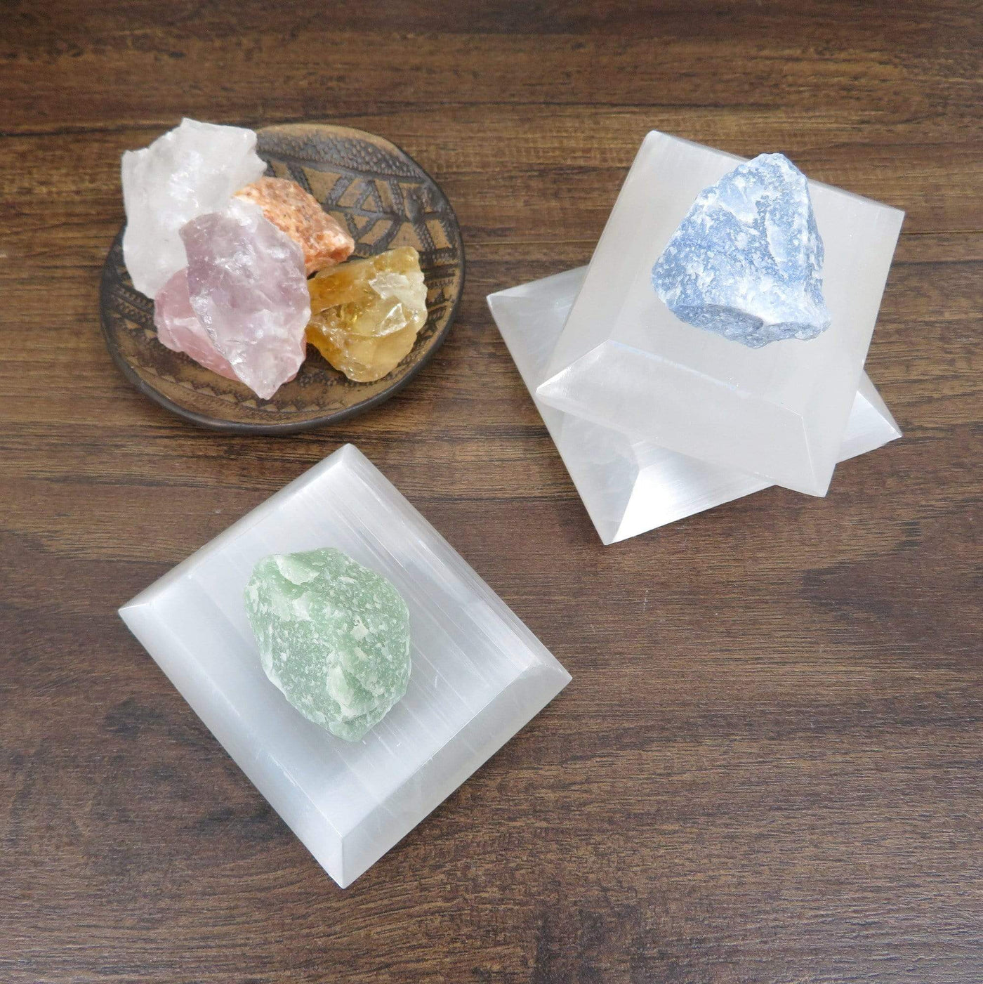 selenite square charging plates on display with charging stones
