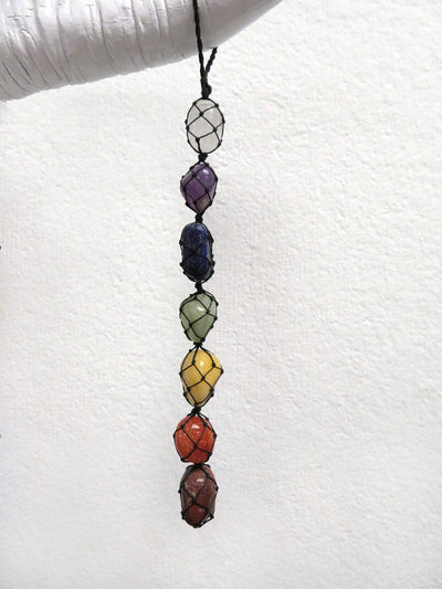chakra stones in net wall hanging displayed as home decor 
