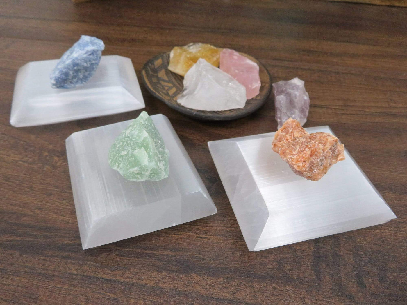 selenite square charging plates on display with charging stones for size reference