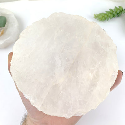 hand holding up Crystal Quartz Display Bowl showing bottom of it
