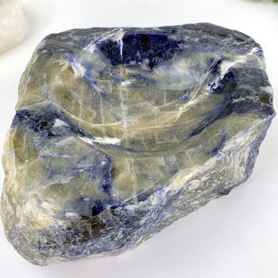 another close up angle of semi-polished sodalite bowl on display for details