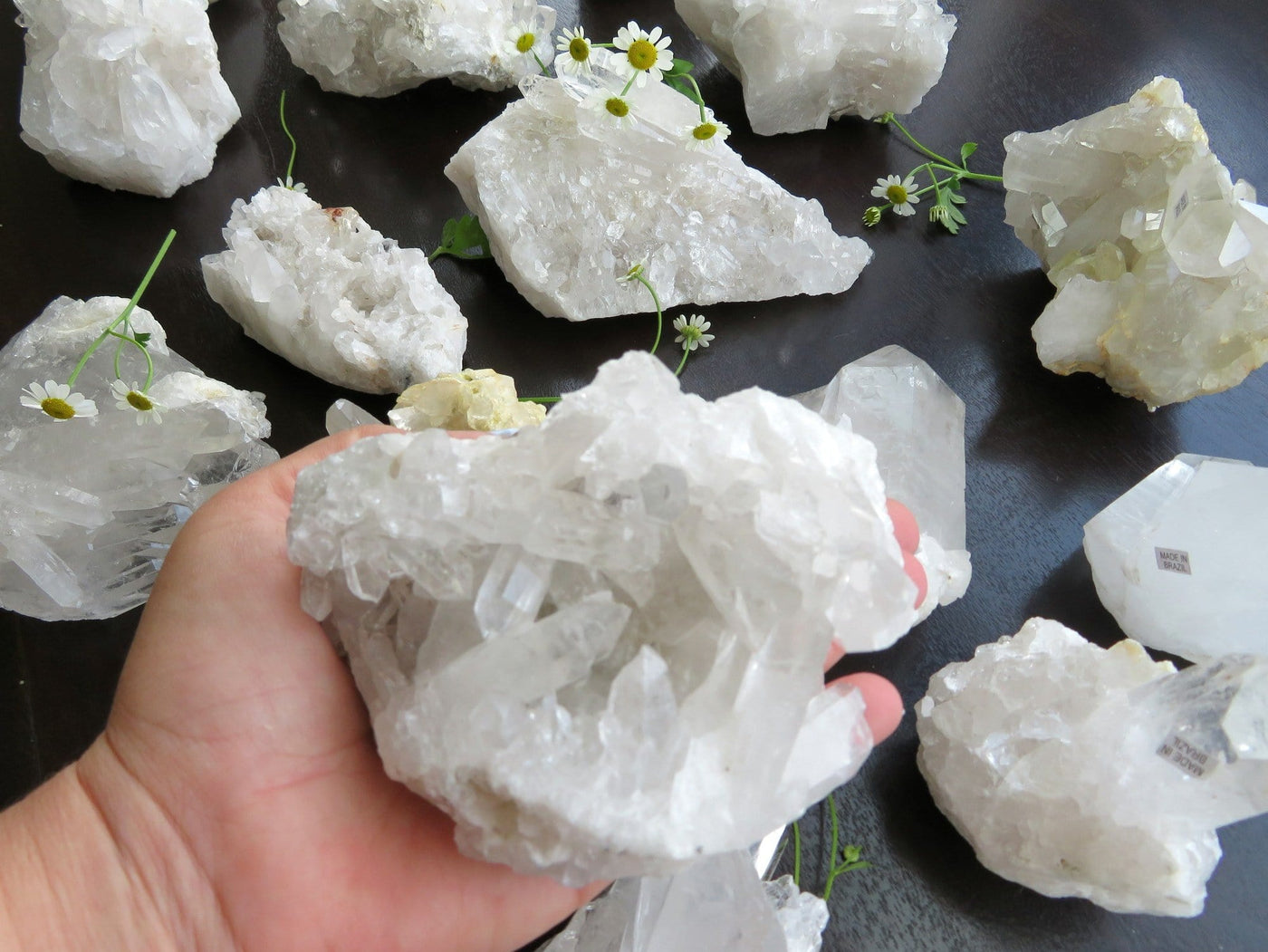 hand holding crystal cluster with others in the background