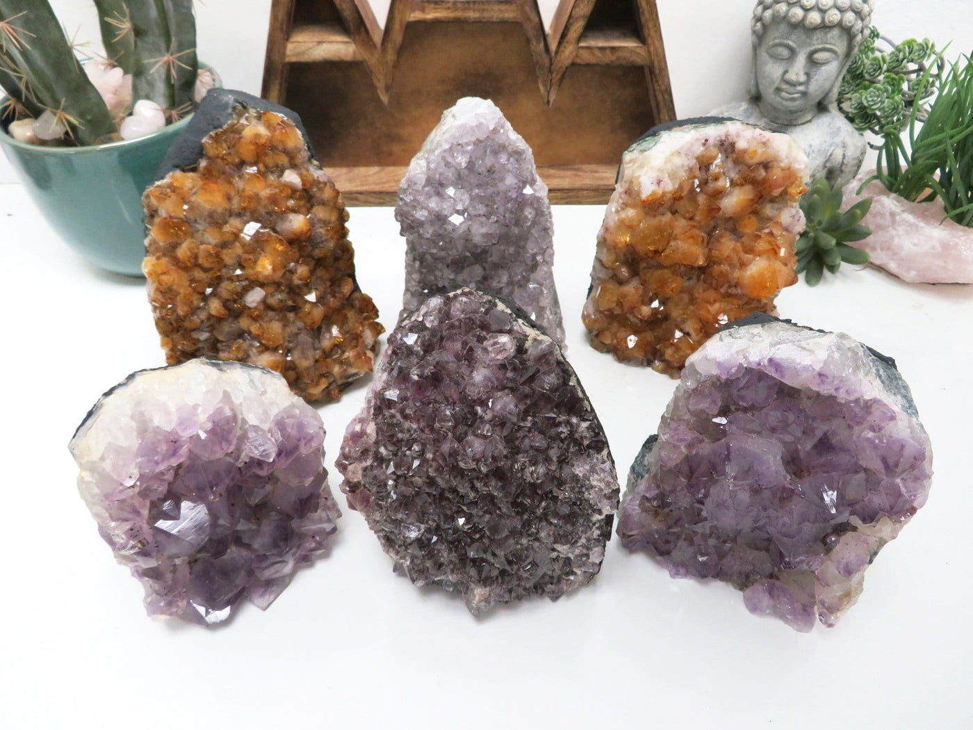 multiple Amethyst and Citrine (heat treated amethyst) Cluster Geode Cut Bases displayed to show various formations and color hues