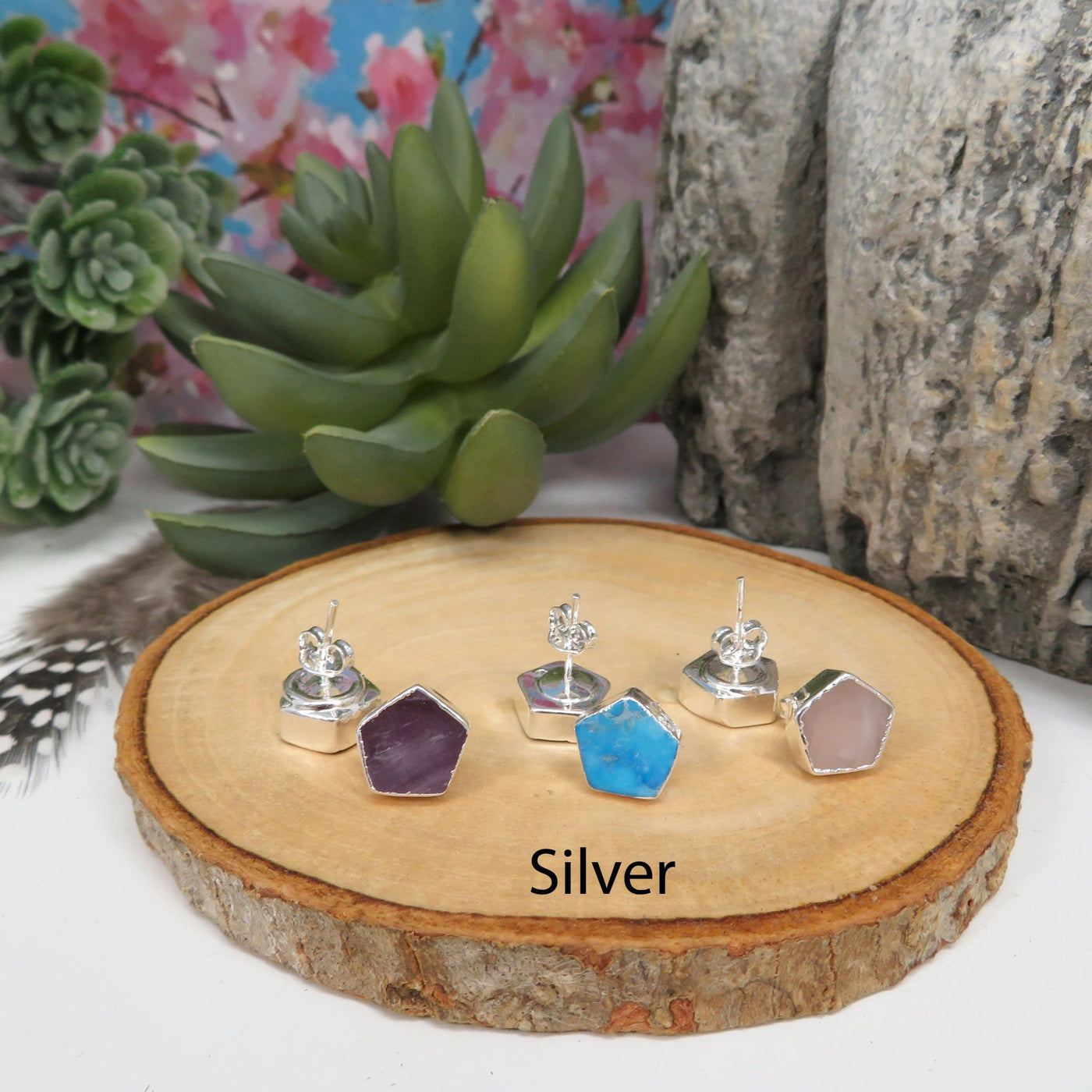 silver stud earrings on a table