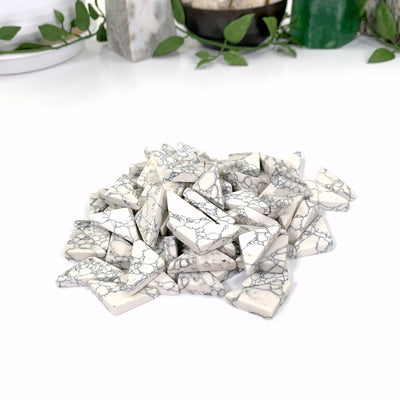 a pile of white howlite triangles witha white background
