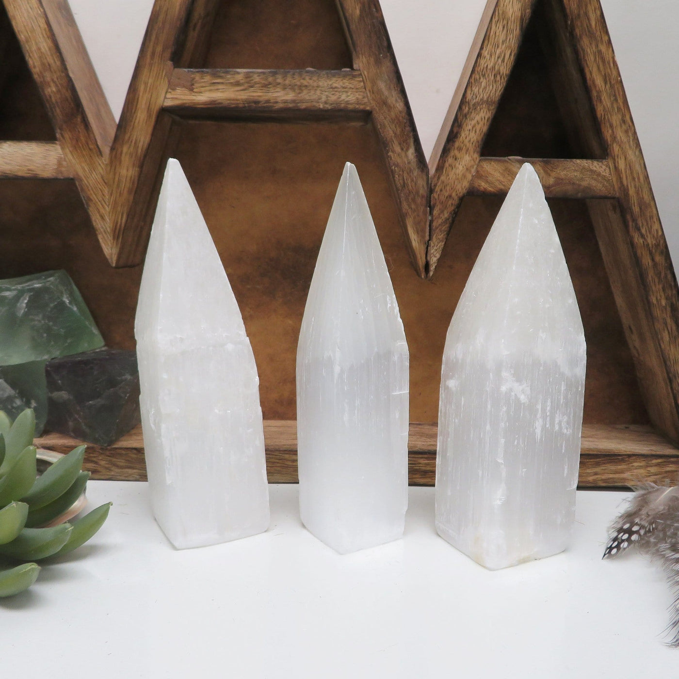 three selenite tower obelisk points on display for possible variations