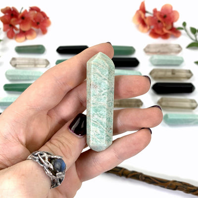 Close Up of Amazonite in Hand With White Background.