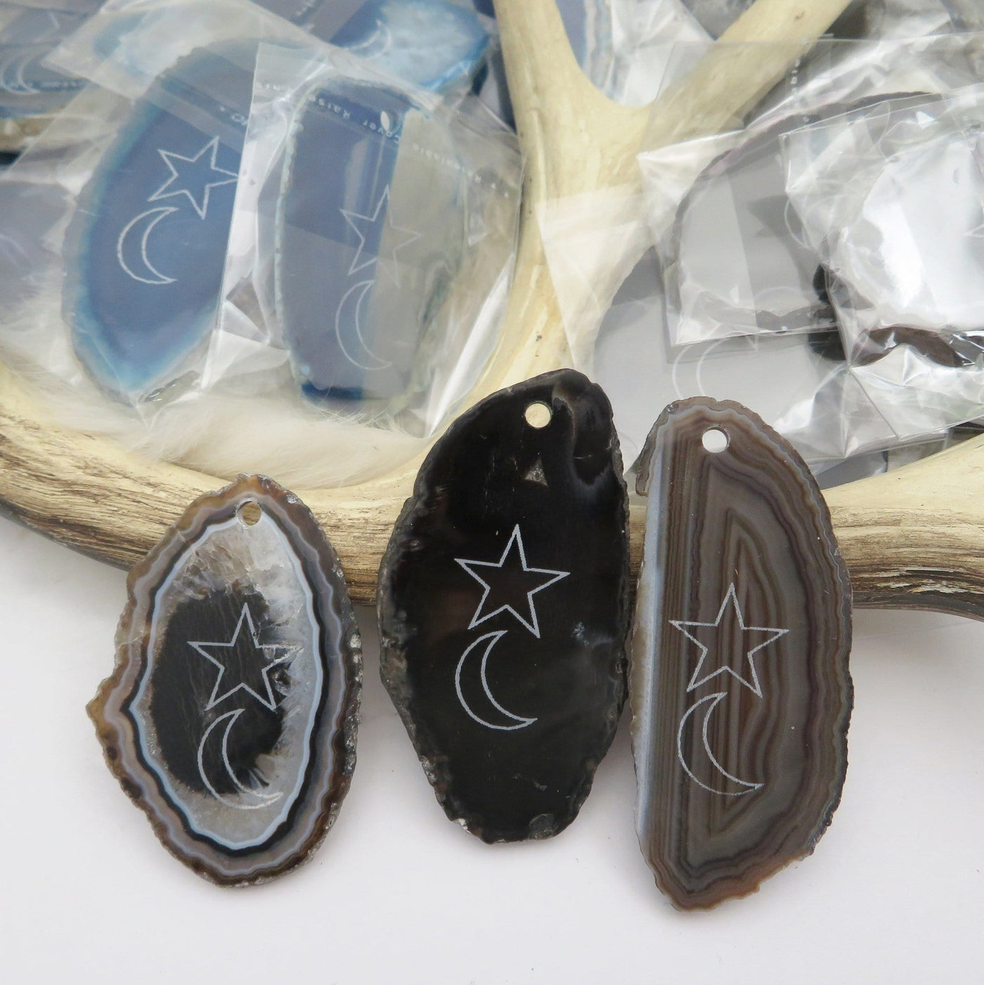 Picture of three black  agate slices double drilled.
