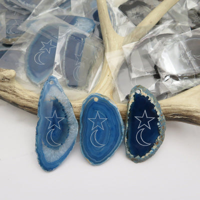 Picture of three blue agate slices double drilled.