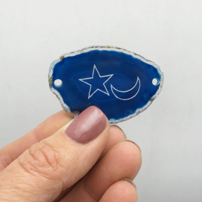 Picture of one blue agate slice drilled, in hand for size reference.