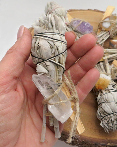 sage bundle with crystal quartz in hand for size reference and possible variation