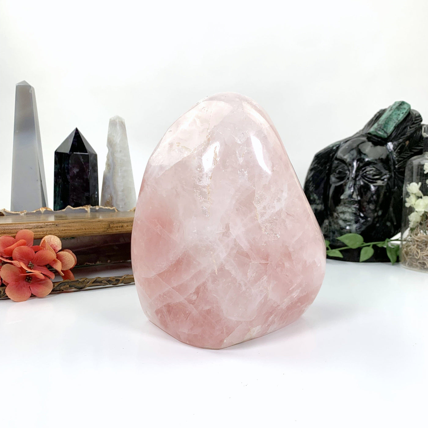 Different angle rose quartz sitting on white background
