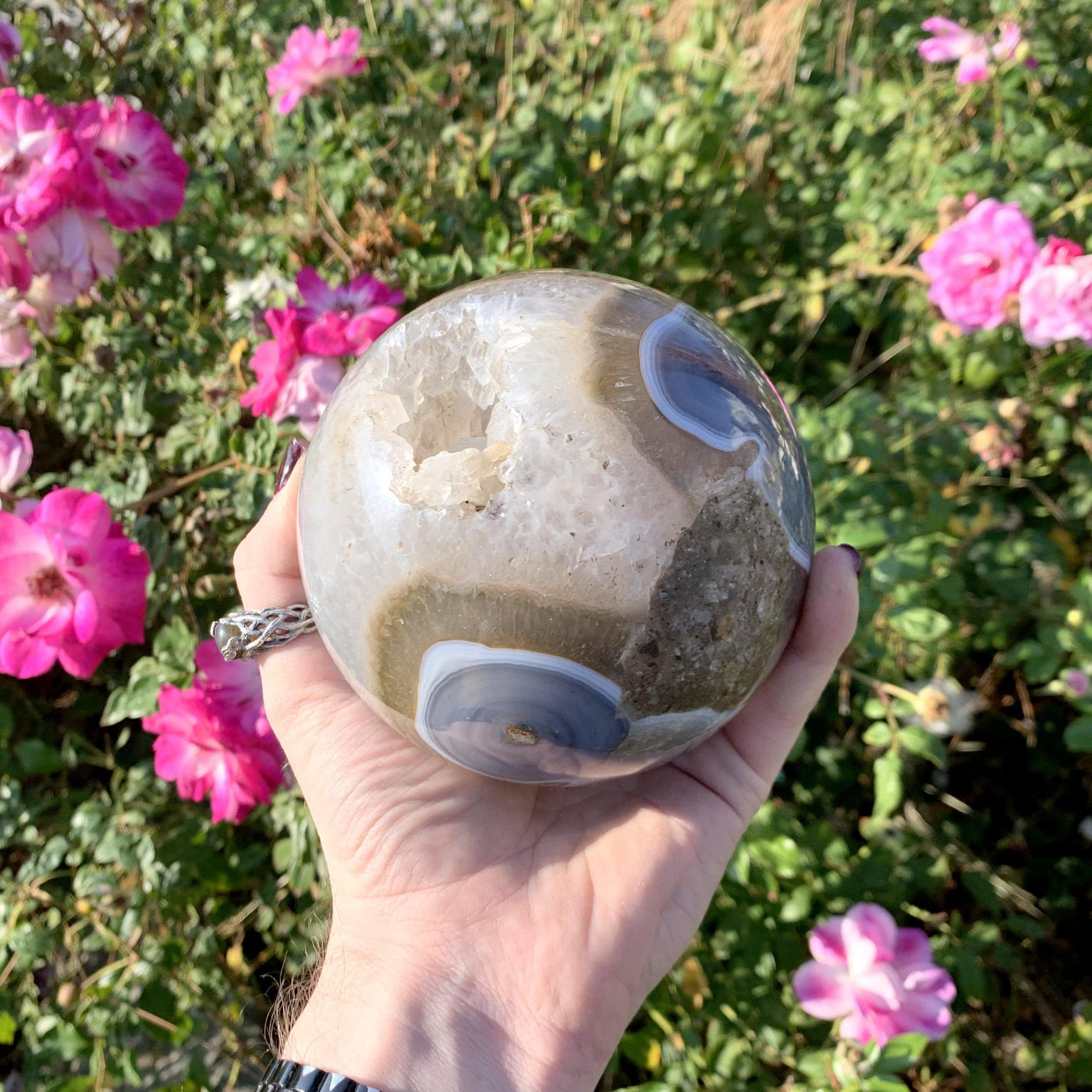 Natural Agate Druzy Sphere in a hand with big swirls