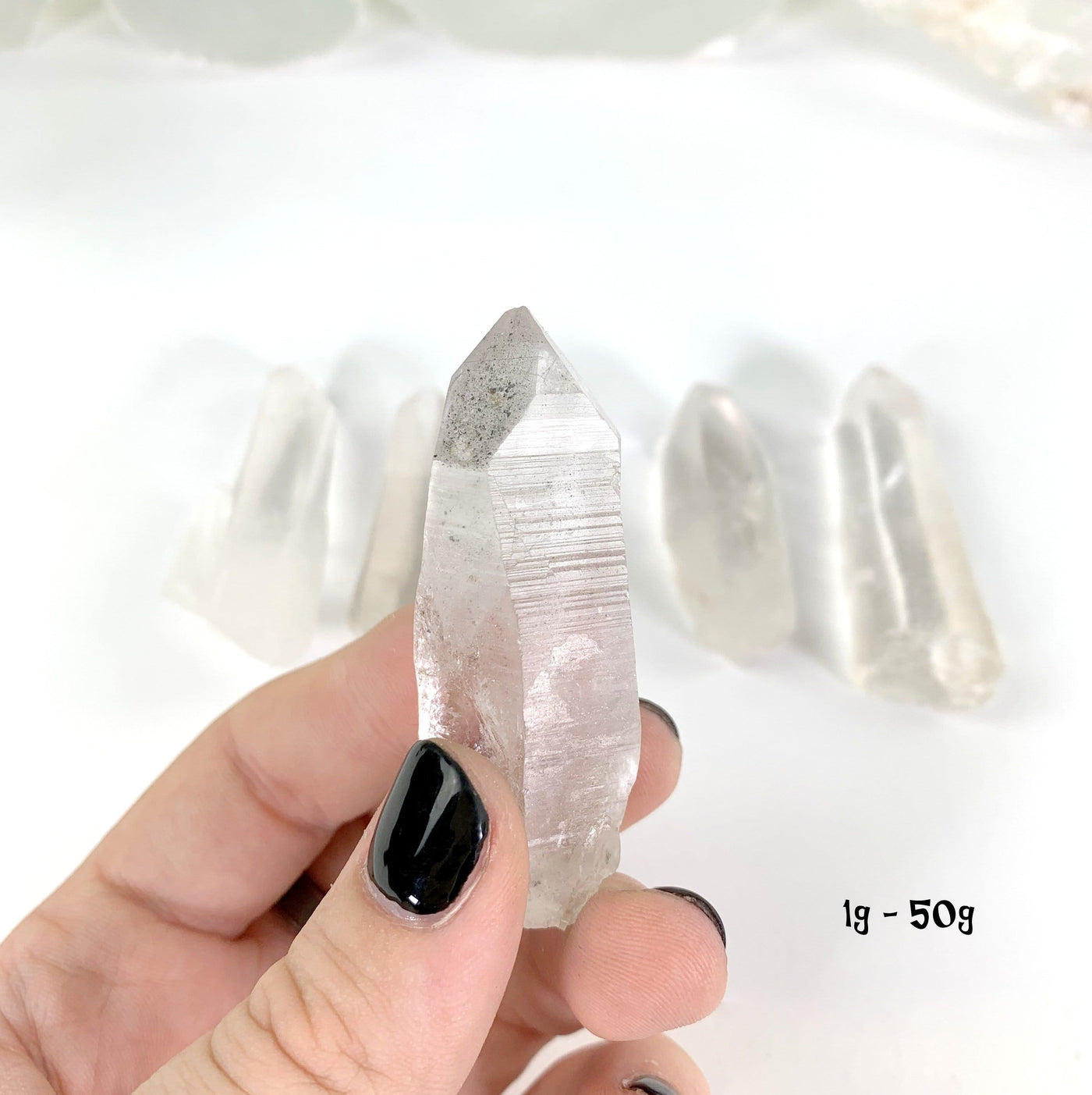 Natural Lemurian Quartz Points in weight 1g-50g in hand for size reference