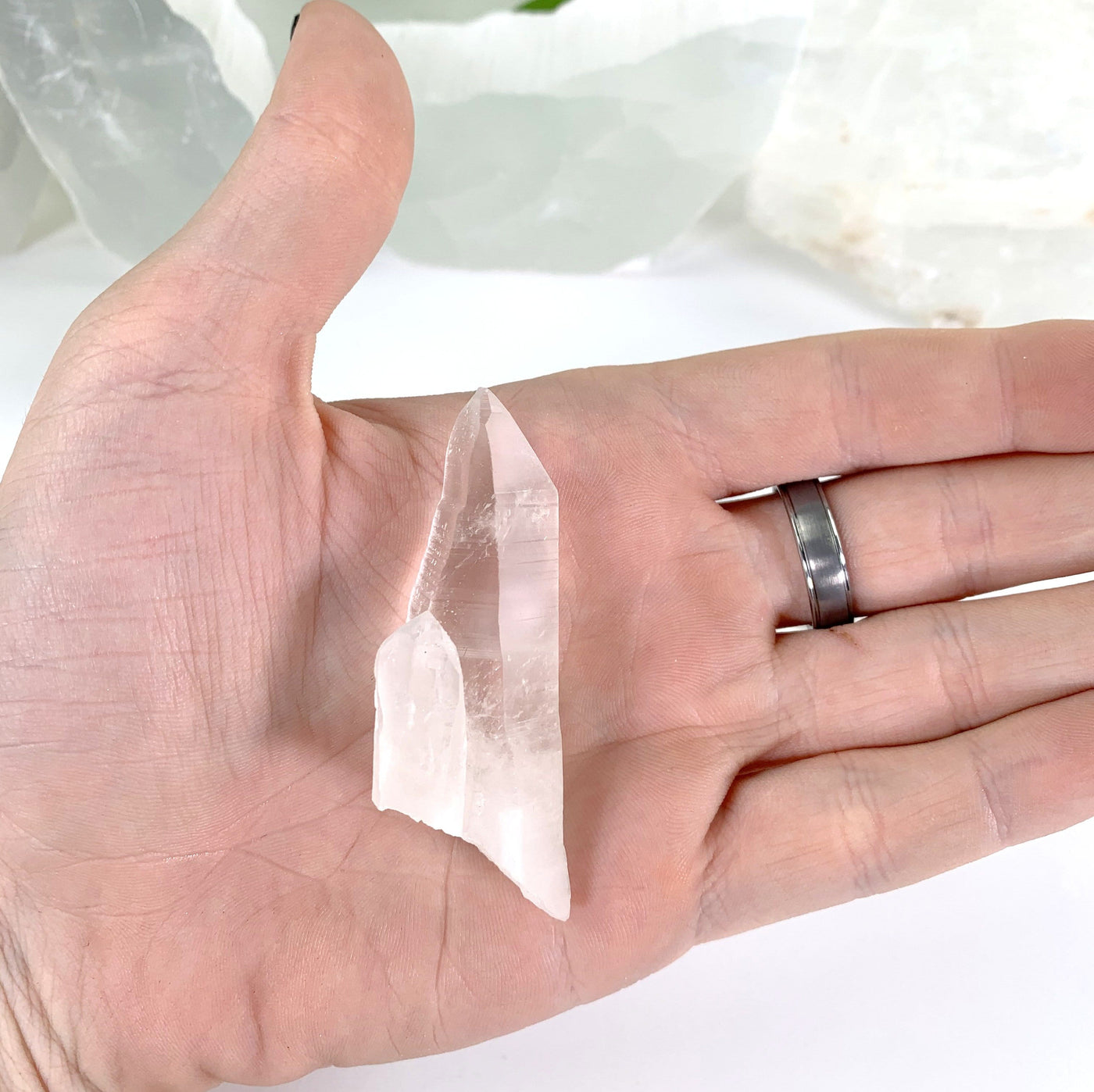 Natural Lemurian Quartz Point in hand for size reference