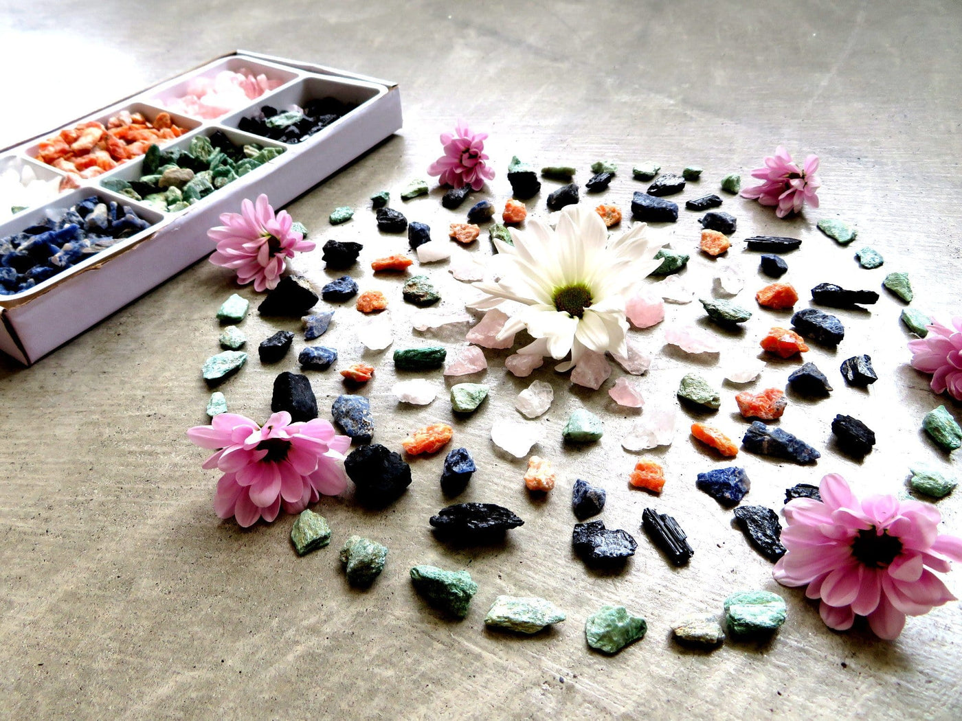 Rough Stone Mixed Set Crystal Grid with flowers next to box of mixed crystals