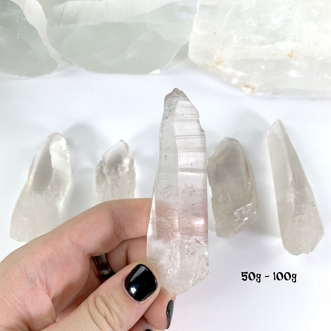 Natural Lemurian Quartz Points in weight 50g-100g in hand for size reference