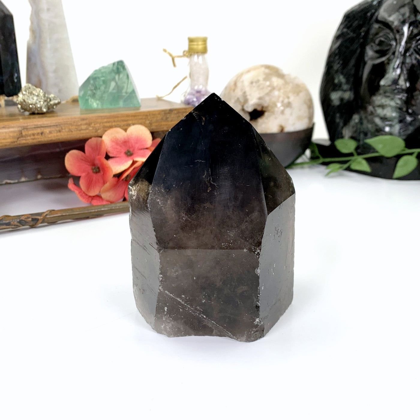 front of Smoky quartz point sitting on a white background