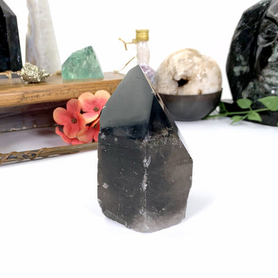 Side view of Smoky quartz point sitting on a white background