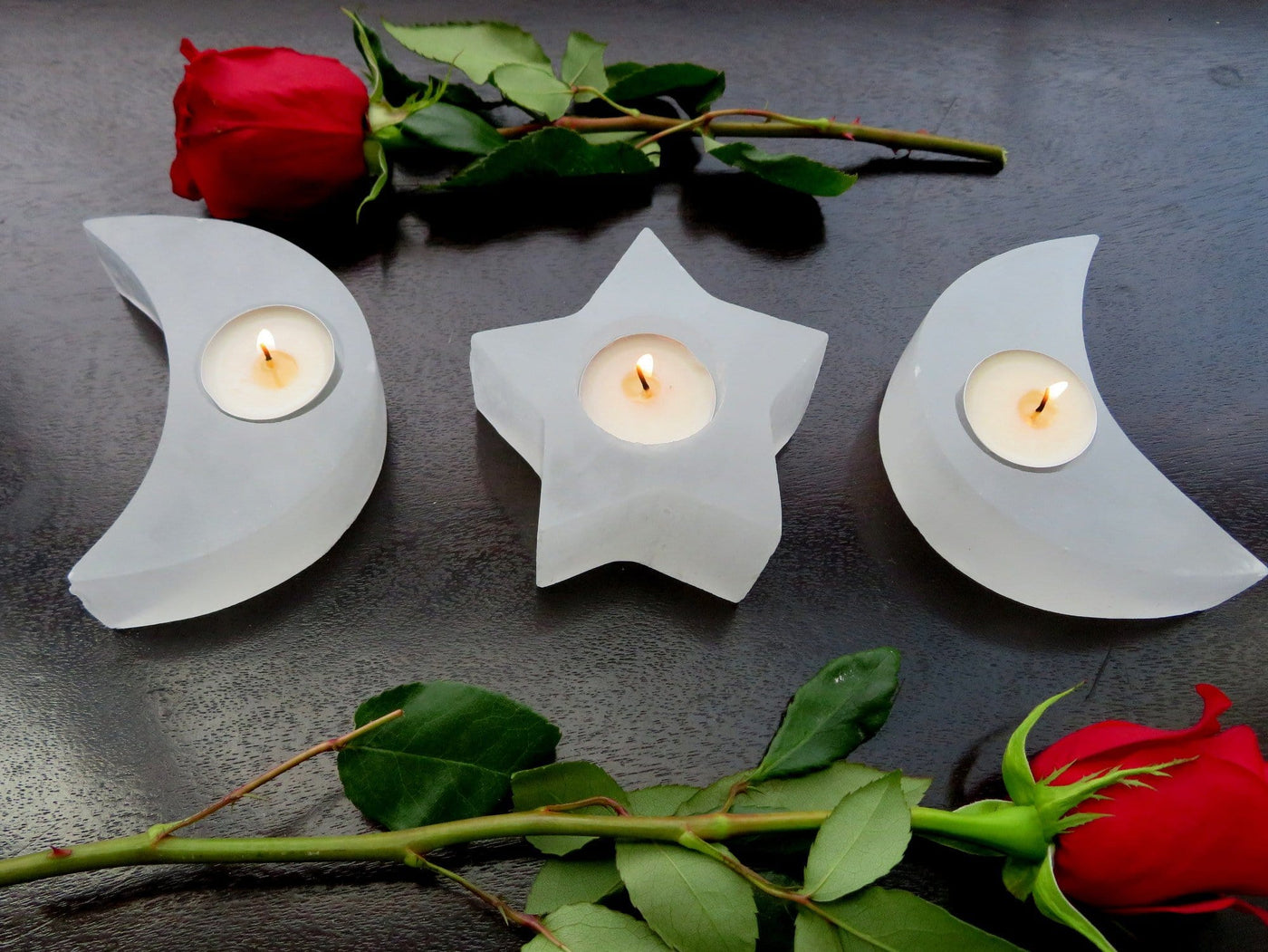 selenite crescent moon and star candle holders on display