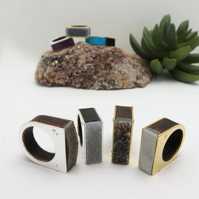 4 assorted druzy rings on a white background to show the druzy color ranges from dark gray to brown.