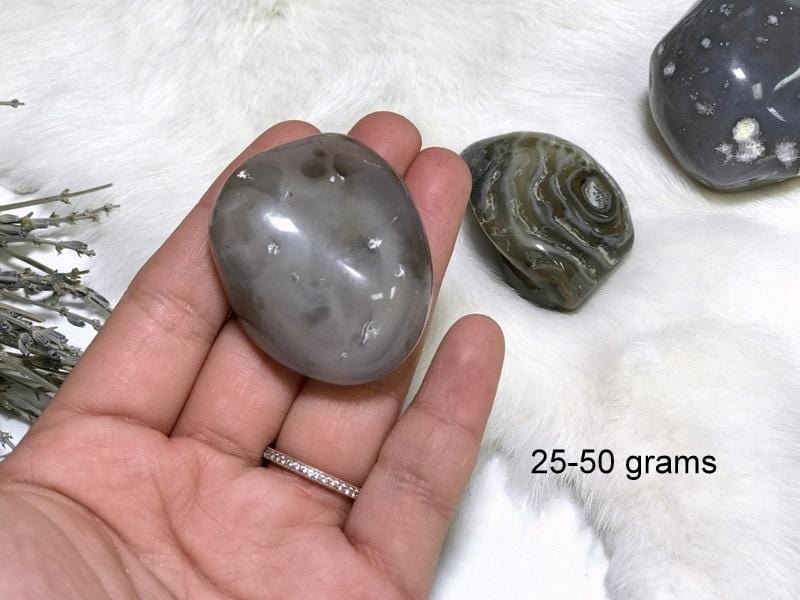 Enhydro Polished Agate Geode in hand showing the weigh of 25 to 50g.