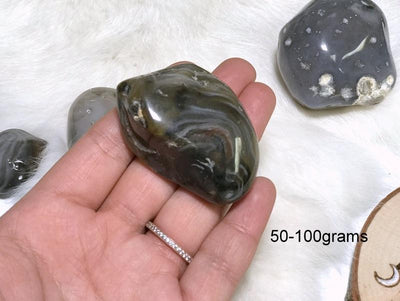 Enhydro Polished Agate Geode in hand showing the weigh of 50 to 100grams.