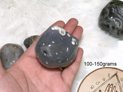 Enhydro Polished Agate Geode in hand showing the weigh of 100 to 150grams.