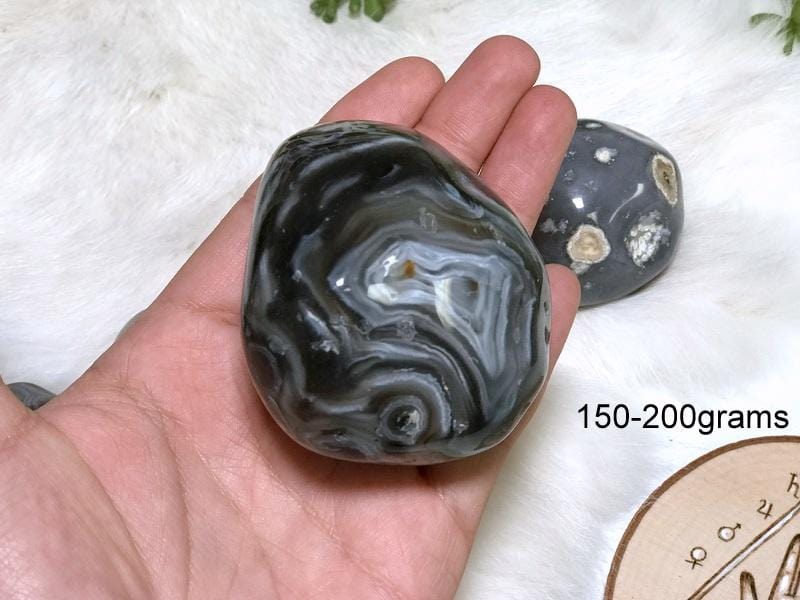 Enhydro Polished Agate Geode in hand showing the weigh of 150 to 200grams.