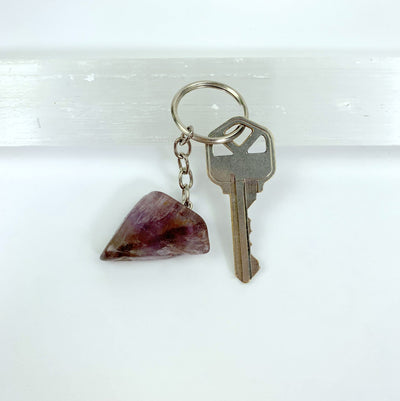 close up fo one seven mineral amethyst slab keychain with key for details