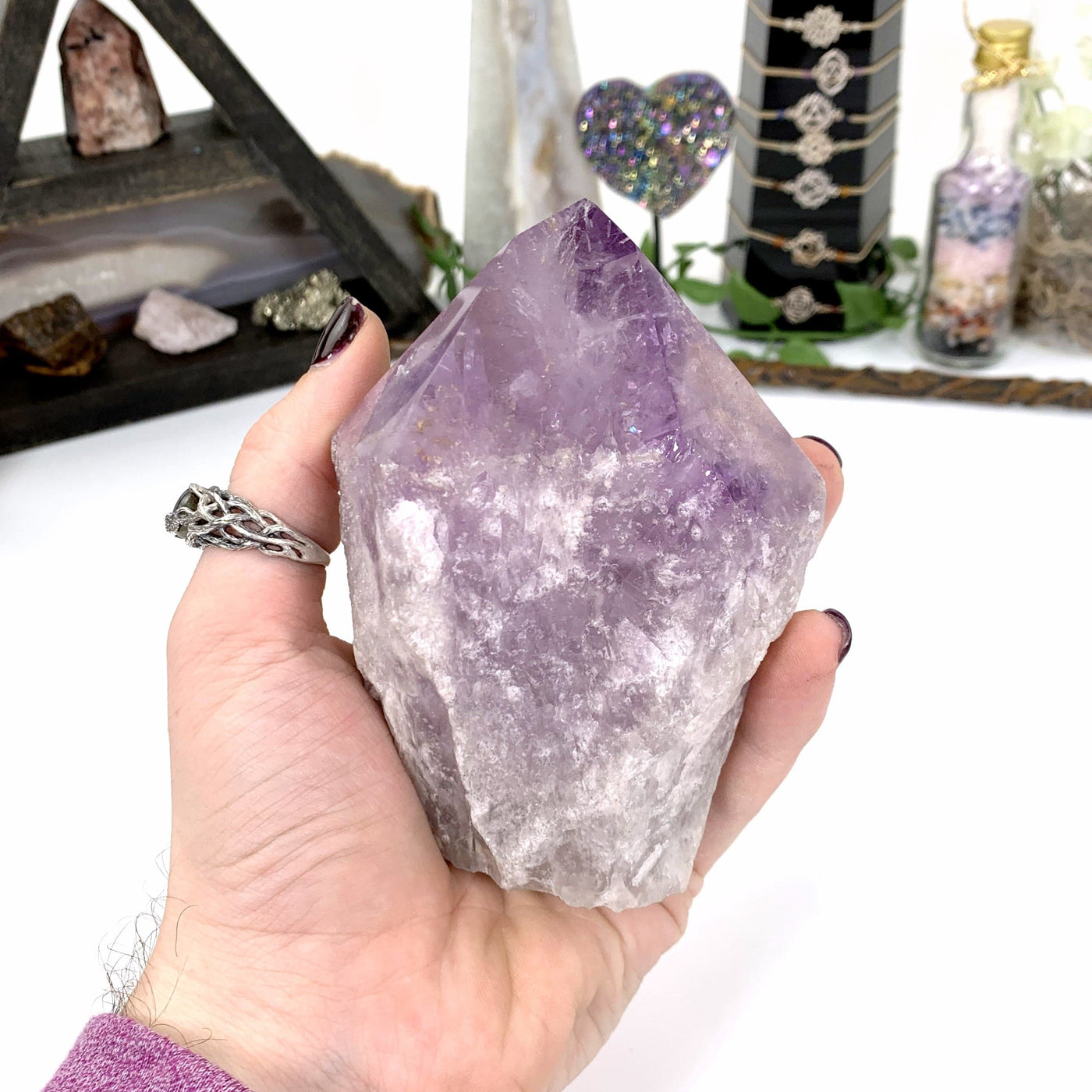 amethyst point in hand with white background
