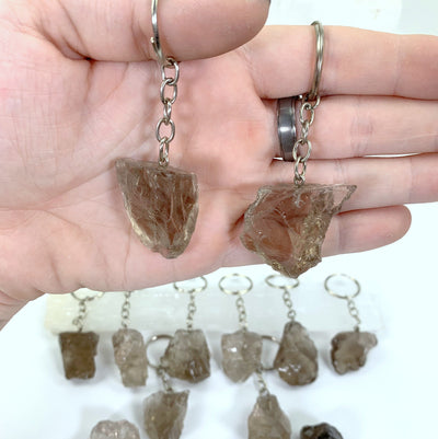 Natural Smoky Quartz Keychains - 2 held in a hand