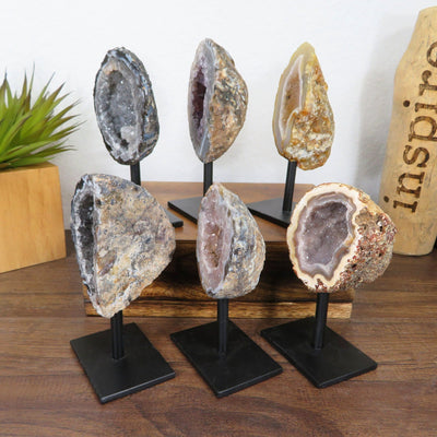 angled shot of 6 geode home decor stands with decorations
