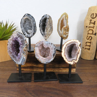 6 geodes on metal stands with decorations