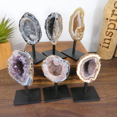 6 geodes on metal stands with decorations
